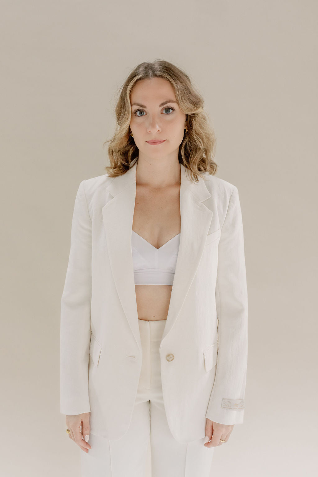 Product shot of white less support in business suit outfit